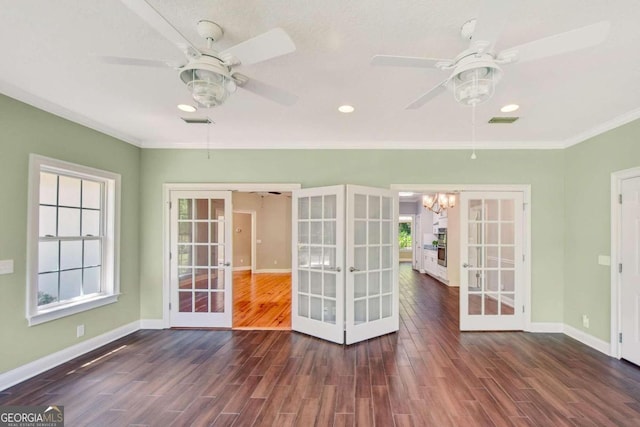 unfurnished room featuring french doors, dark wood finished floors, baseboards, and ceiling fan with notable chandelier