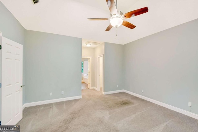 unfurnished room featuring light carpet, ceiling fan, and baseboards