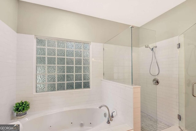 full bath featuring a shower stall and a whirlpool tub