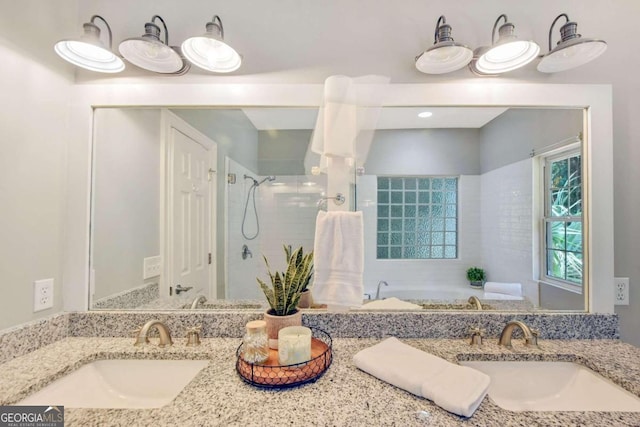 full bathroom with a shower stall, a bath, and vanity