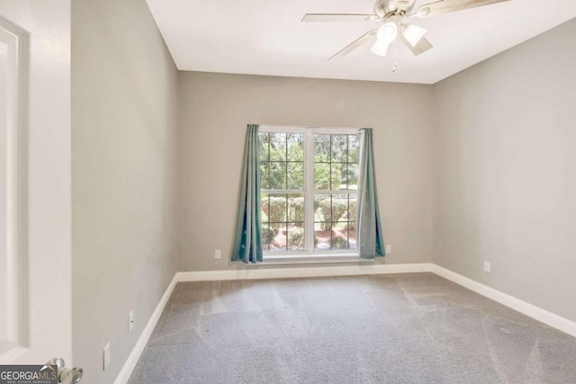 empty room with ceiling fan, carpet, and baseboards