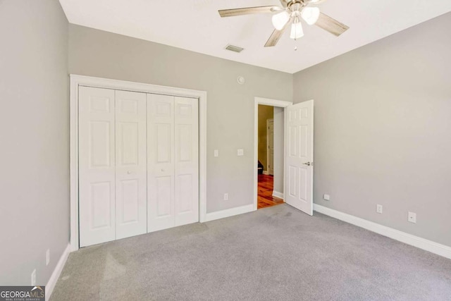 unfurnished bedroom with carpet, a closet, visible vents, ceiling fan, and baseboards