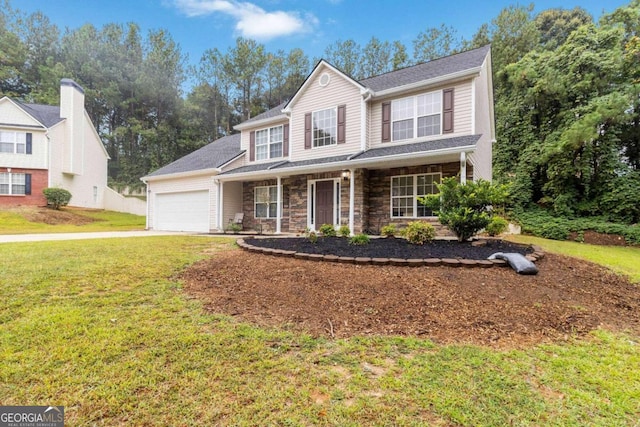 view of front of home with a front lawn, covered porch, and a garage