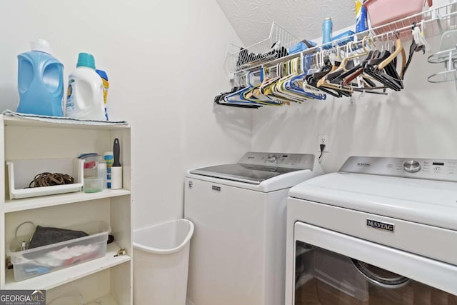 clothes washing area featuring washer and dryer and a textured ceiling