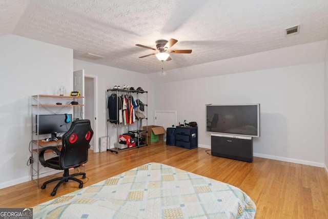 bedroom featuring wood-type flooring and a textured ceiling