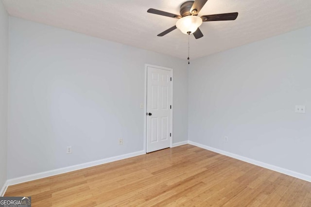 spare room featuring light hardwood / wood-style floors and ceiling fan