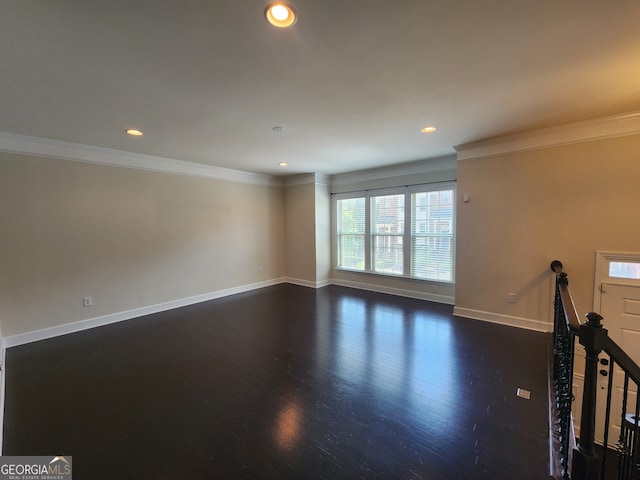 unfurnished living room with dark hardwood / wood-style floors and crown molding