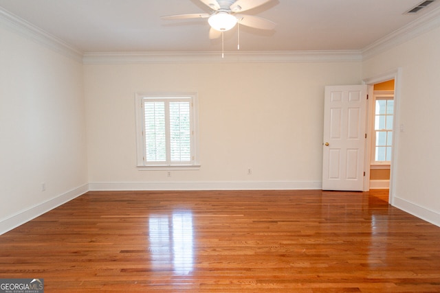 empty room with ceiling fan, hardwood / wood-style flooring, and crown molding