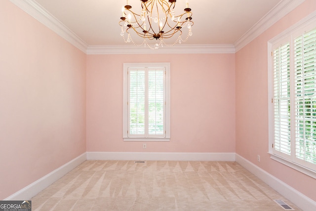 spare room with crown molding, a chandelier, and a wealth of natural light