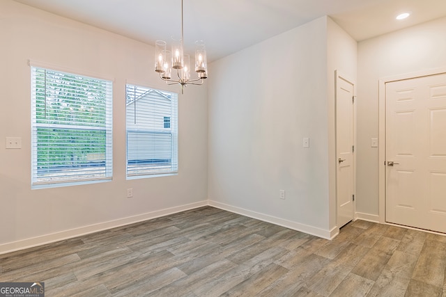 interior space featuring hardwood / wood-style flooring and a chandelier