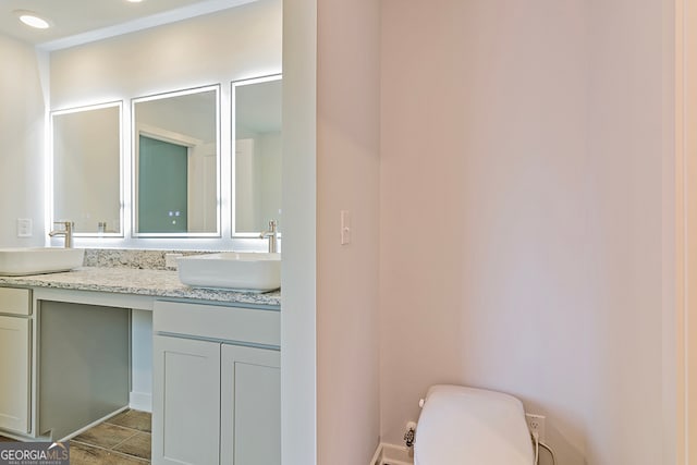 bathroom featuring vanity and toilet