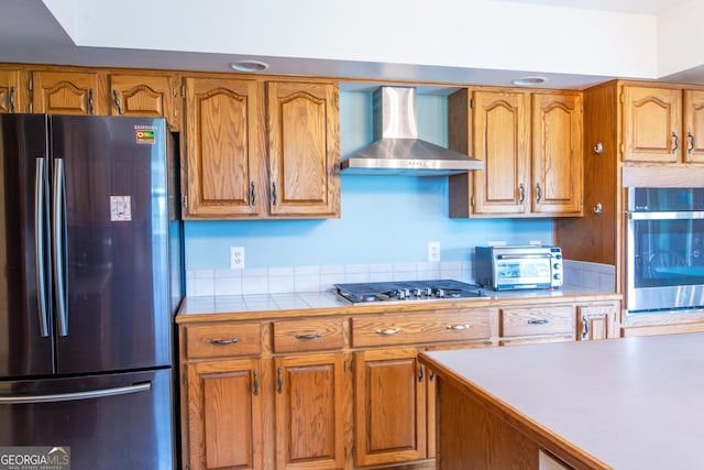 kitchen featuring appliances with stainless steel finishes and wall chimney exhaust hood