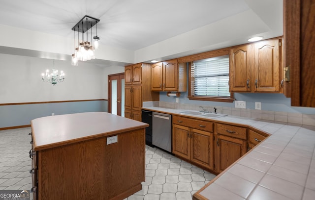 4909 Perry Rd, Claxton, GA 30417 - kitchen with dishwasher, a center island, brown cabinetry, tile counters, and a chandelier