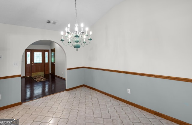 4909 Perry Rd, Claxton, GA 30417 - spare room featuring arched walkways, a chandelier, and vaulted ceiling