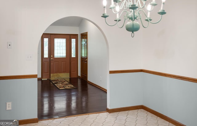 4909 Perry Rd, Claxton, GA 30417 - entrance foyer featuring arched walkways and a chandelier