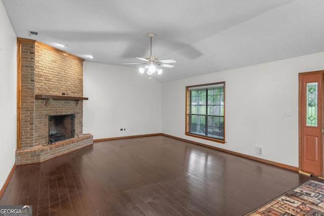 4909 Perry Rd, Claxton, GA 30417 - unfurnished living room with ceiling fan, a brick fireplace, and dark wood finished floors