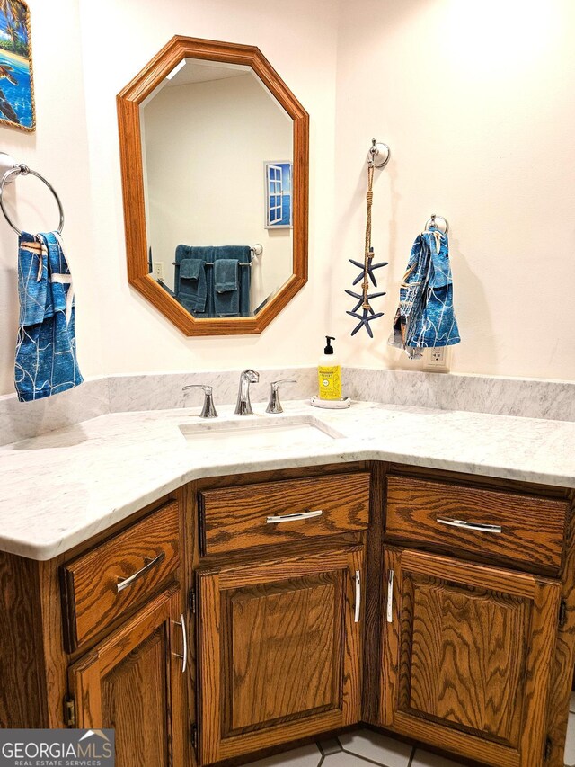 bathroom featuring tile patterned floors, vanity, and toilet