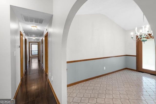 4909 Perry Rd, Claxton, GA 30417 - hall with vaulted ceiling, arched walkways, and a chandelier