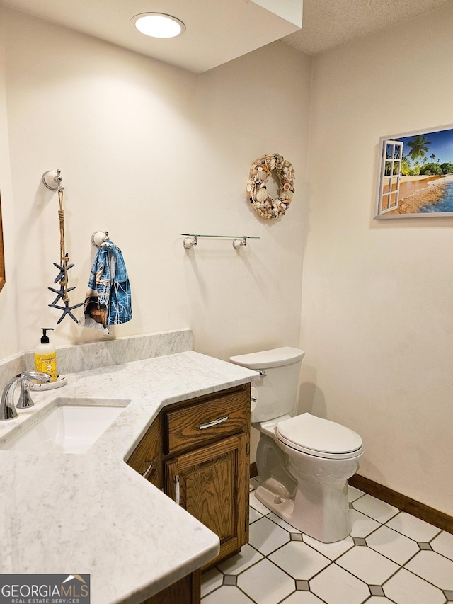 bathroom featuring toilet and vanity