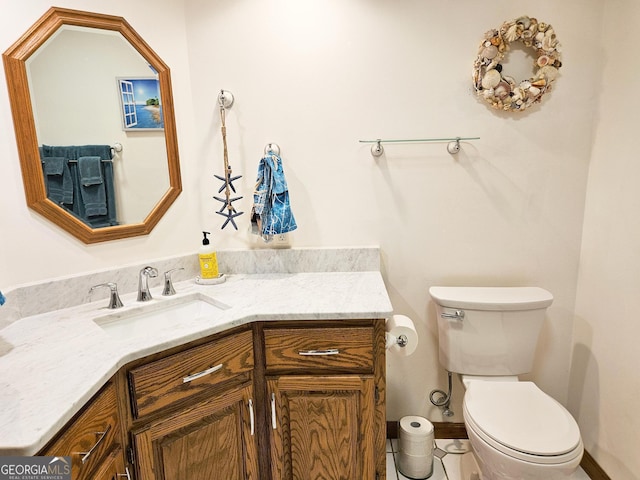 bathroom with toilet and vanity