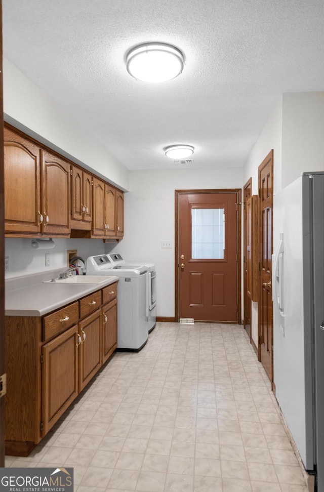 4909 Perry Rd, Claxton, GA 30417 - washroom with cabinet space, washing machine and dryer, and a textured ceiling