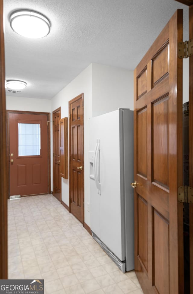 4909 Perry Rd, Claxton, GA 30417 - foyer with light floors and a textured ceiling