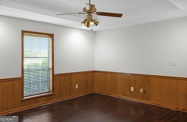 4909 Perry Rd, Claxton, GA 30417 - empty room featuring a wainscoted wall, ceiling fan, wood finished floors, and wooden walls