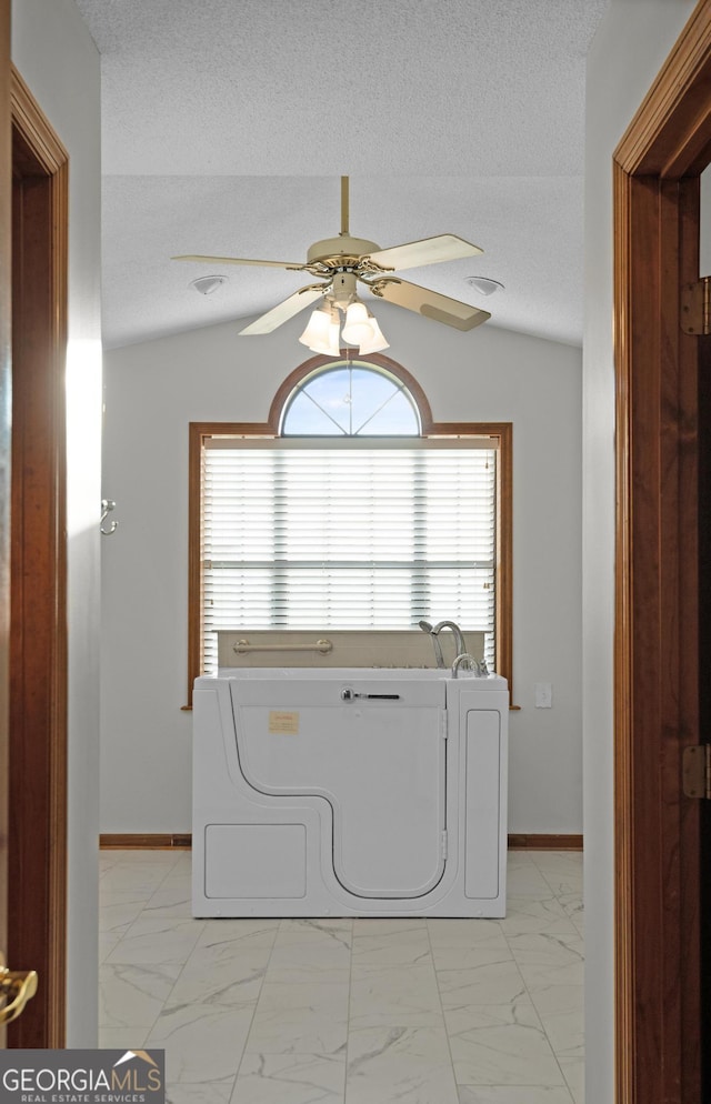 4909 Perry Rd, Claxton, GA 30417 - laundry area with light marble finish flooring, a ceiling fan, healthy amount of natural light, and a textured ceiling