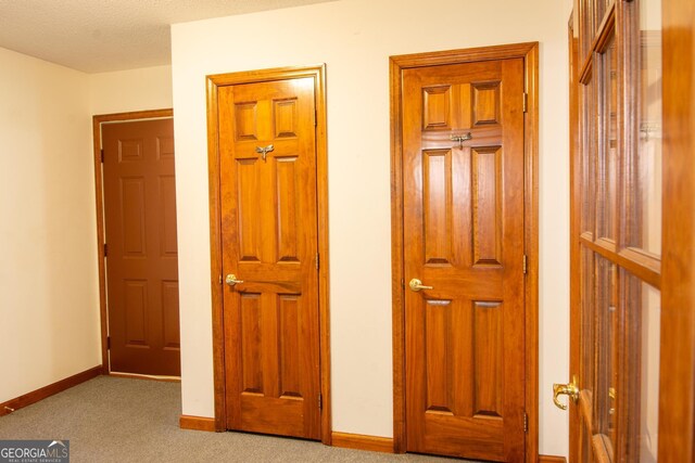 carpeted spare room with ceiling fan and a textured ceiling