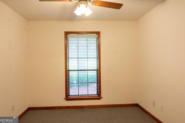 unfurnished room with carpet flooring and ceiling fan