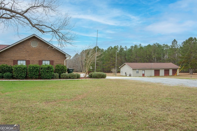 view of side of home featuring a yard and a garage