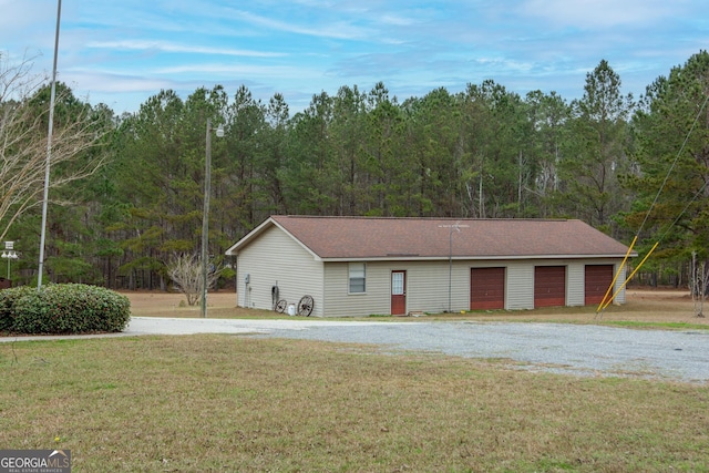 ranch-style home featuring a front yard and a garage