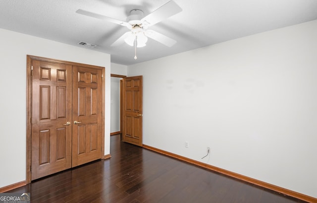4909 Perry Rd, Claxton, GA 30417 - unfurnished bedroom featuring dark wood-style floors and ceiling fan