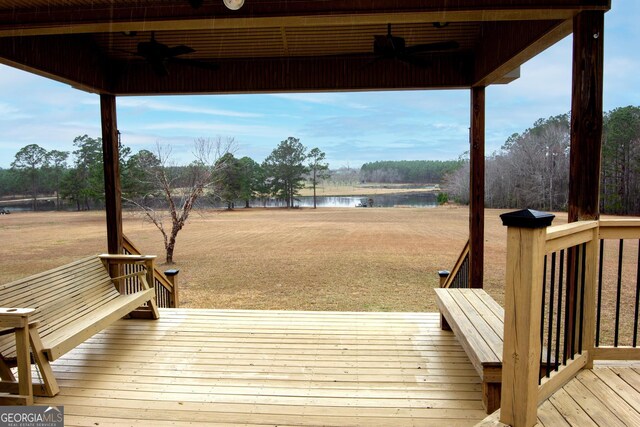 view of front of home with a deck and a front lawn