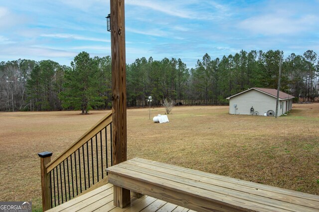 view of yard featuring ceiling fan and a wooden deck