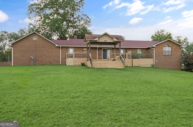 4909 Perry Rd, Claxton, GA 30417 - view of front of house featuring brick siding, a front lawn, a chimney, and a deck
