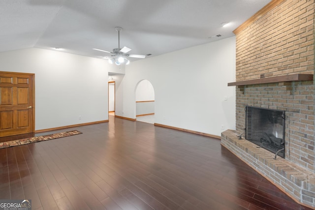 4909 Perry Rd, Claxton, GA 30417 - unfurnished living room with a ceiling fan, a brick fireplace, vaulted ceiling, and wood finished floors