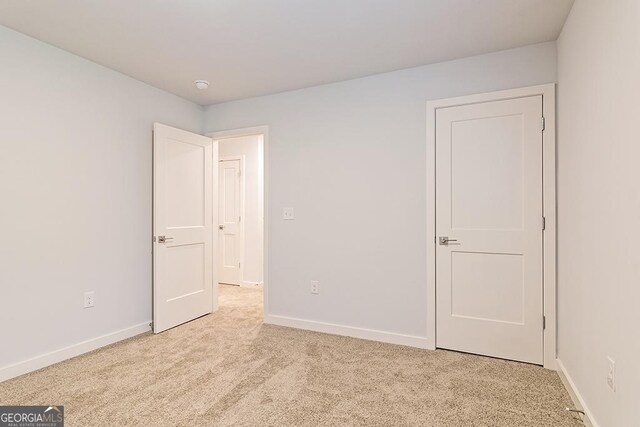 unfurnished bedroom with light carpet