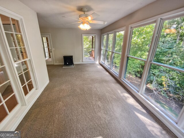 unfurnished sunroom featuring ceiling fan