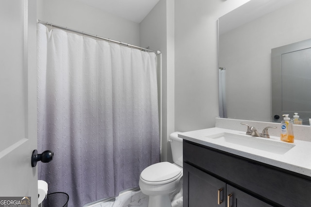 bathroom featuring walk in shower, vanity, and toilet