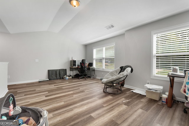 sitting room featuring lofted ceiling and hardwood / wood-style flooring