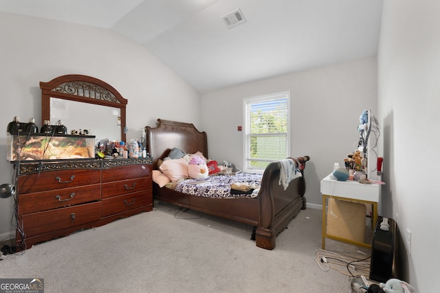 bedroom with lofted ceiling and light colored carpet