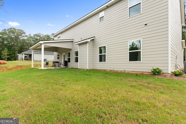 back of property featuring a lawn and a patio area