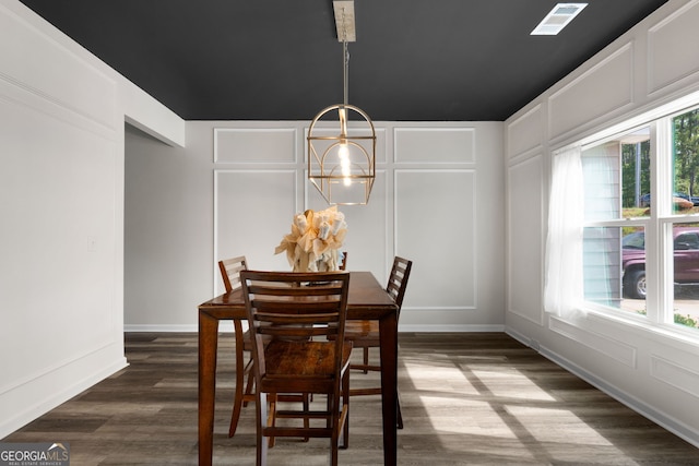 dining area with a notable chandelier, dark hardwood / wood-style floors, and plenty of natural light