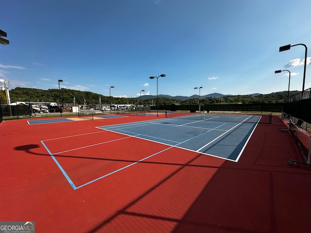 view of tennis court featuring a mountain view