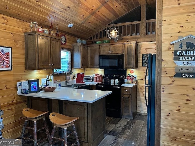 kitchen featuring sink, black appliances, dark hardwood / wood-style floors, wooden ceiling, and vaulted ceiling