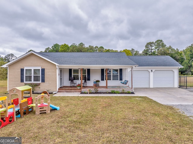 ranch-style home featuring a porch, a garage, and a front yard