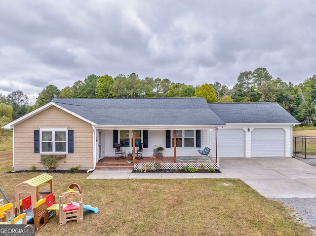 ranch-style home with a front yard, a garage, and a porch