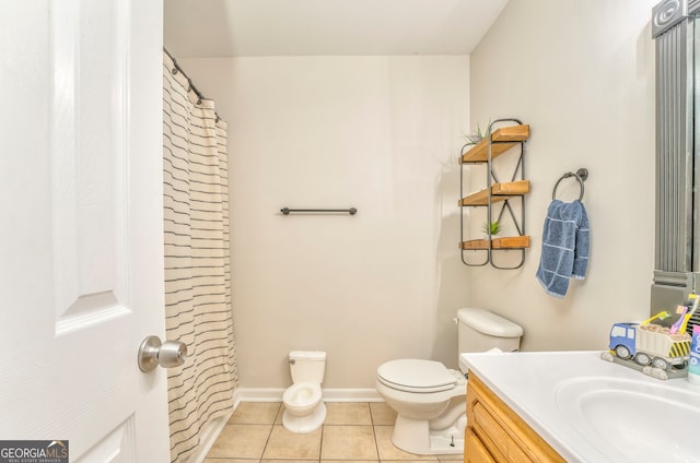 bathroom featuring tile patterned flooring, vanity, and toilet