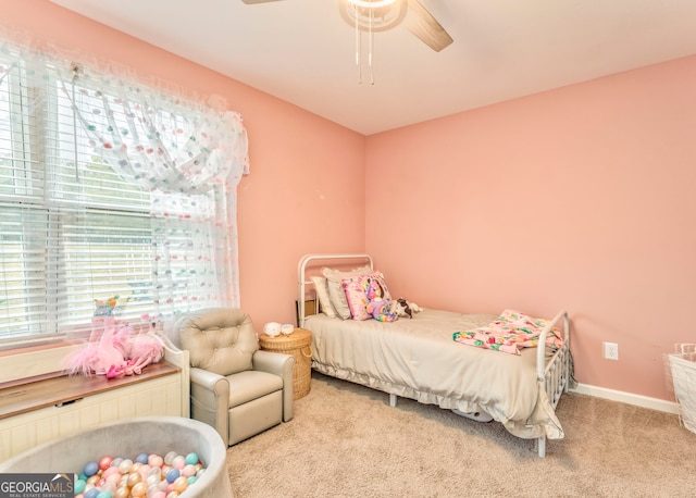 bedroom featuring ceiling fan and carpet